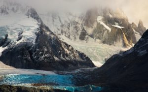 Snowy mountain formation in sunlight